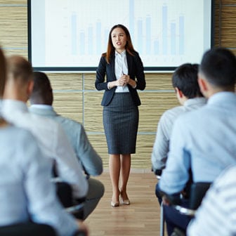 Business woman giving a presentation to a crowd
