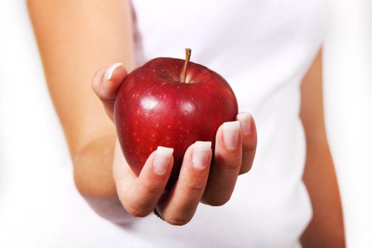Person holding an apple