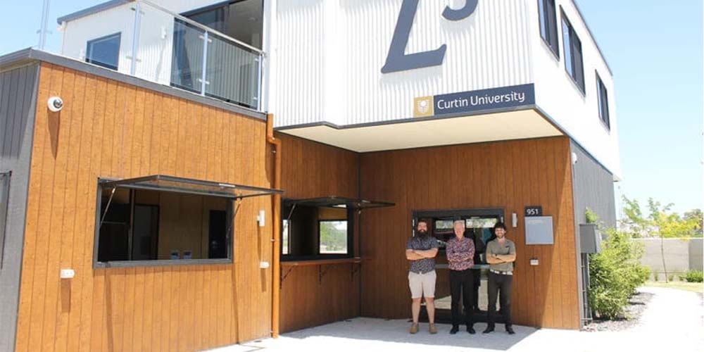 Three sustainable development researchers standing in front of Curtin University's Legacy Living Lab
