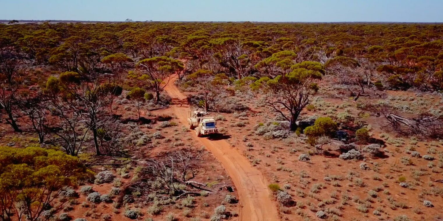 Mining truck driving through the Australian outback - play video