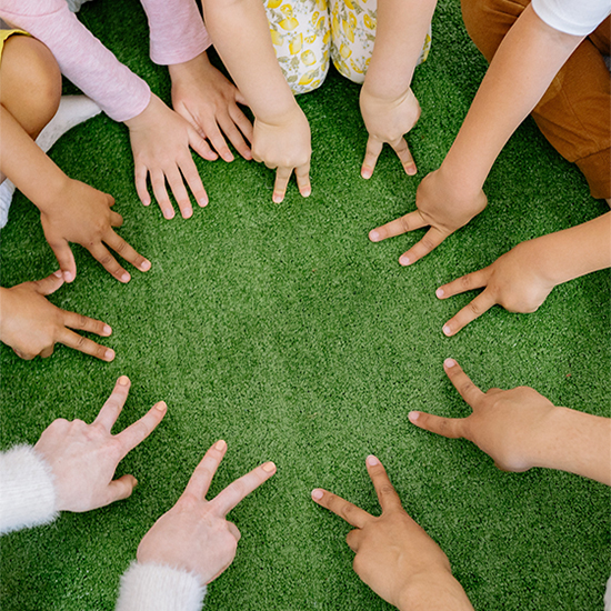 childrens hands in a circle